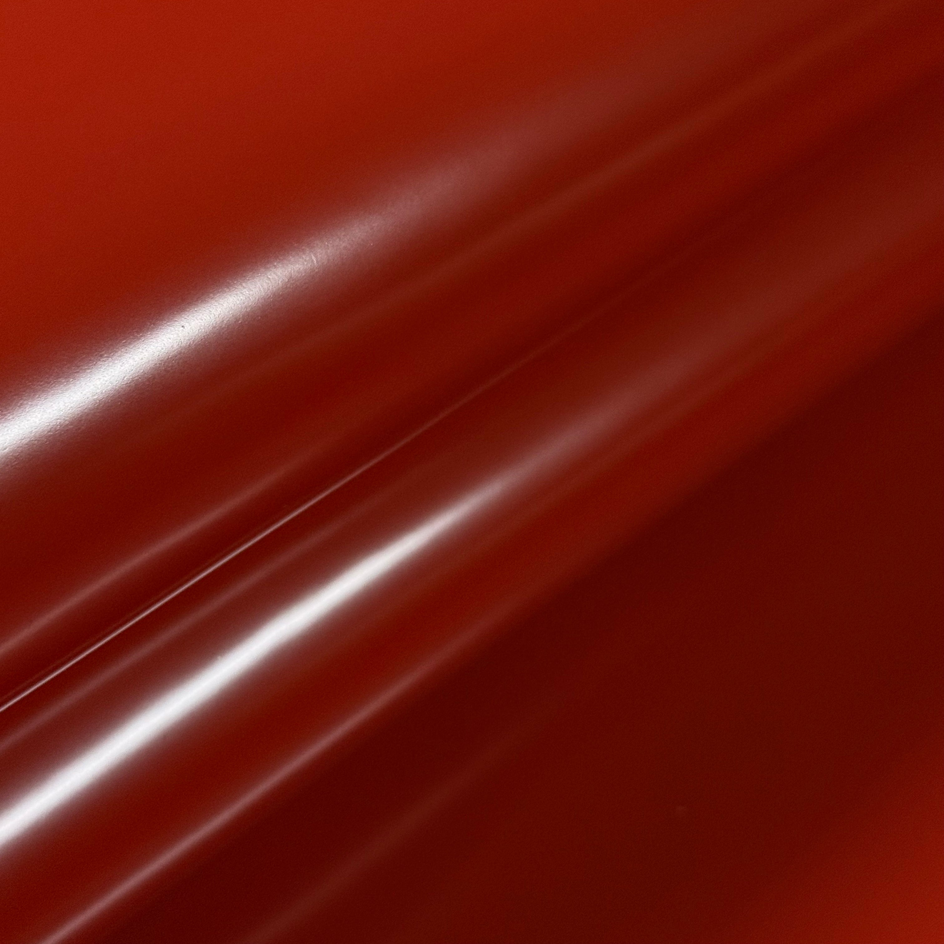 Smooth, polished red cowhide leather with a high-gloss finish, showing subtle folds and reflections.