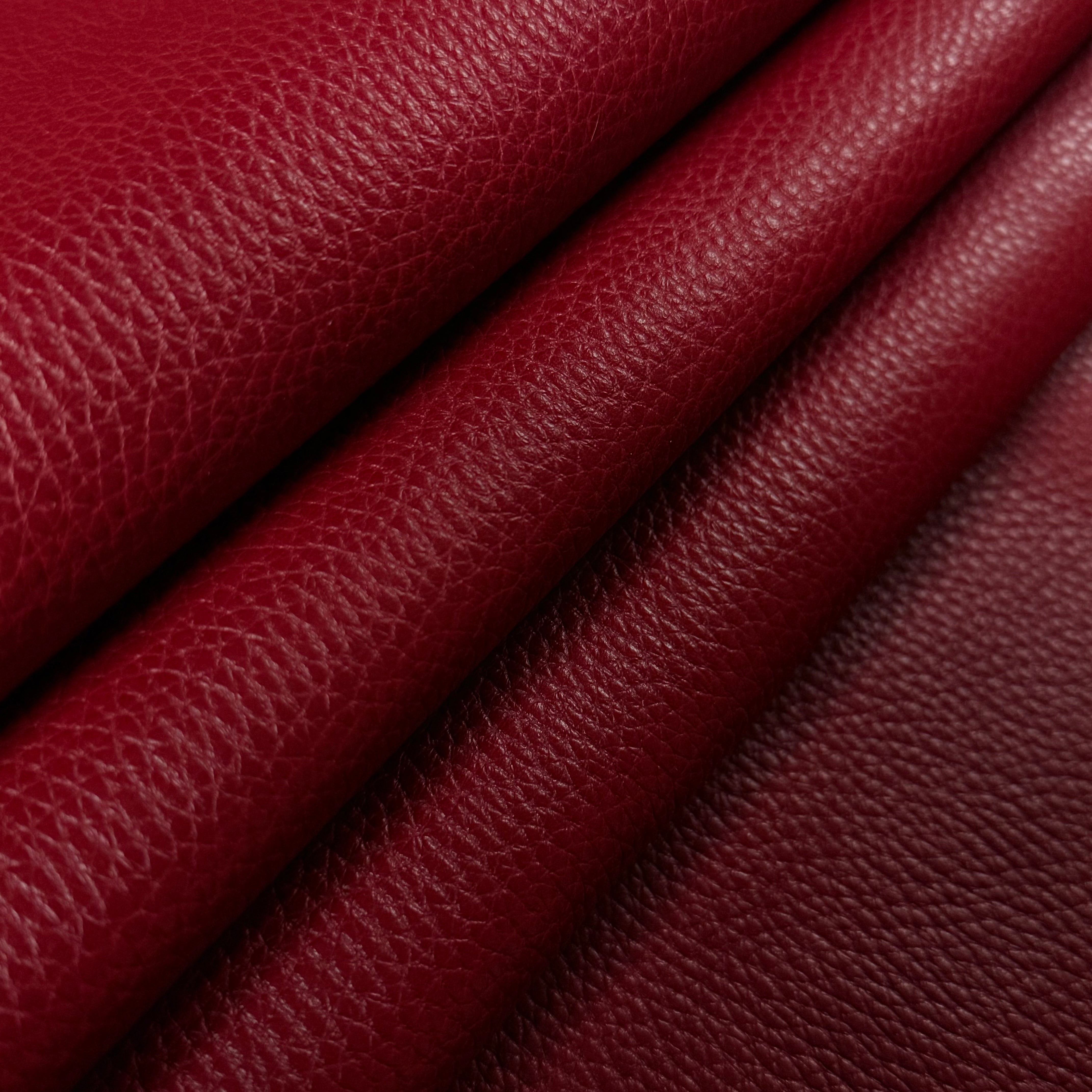 Deep red Pebble Grain Calf leather, 3-4 oz weight, featuring a rich, textured finish folded to show depth.