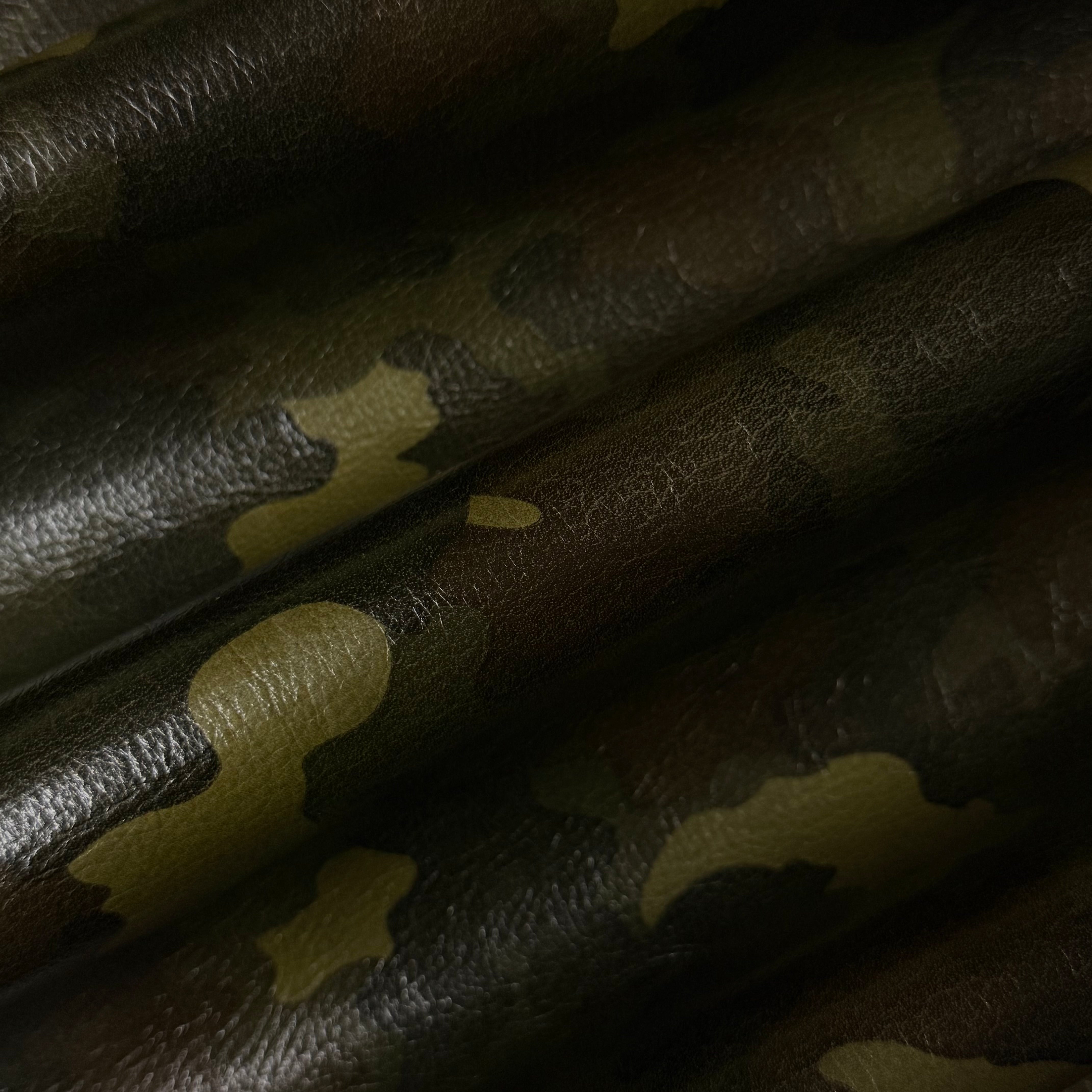 3 oz Camouflage Milled Floater Cow leather in Woodland Camo with a textured, pebbled finish and dark green tones.