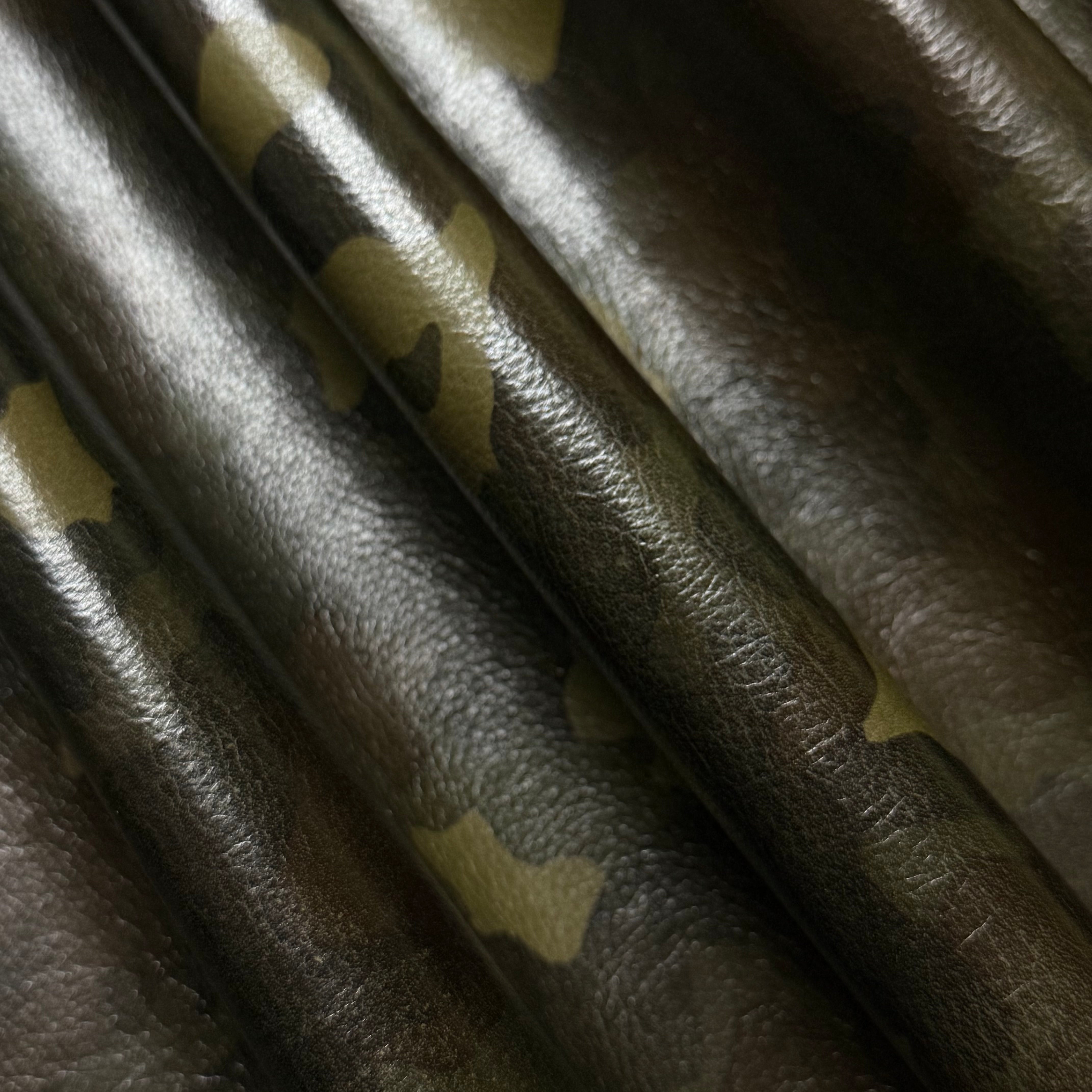 Camouflage Milled Floater Cow 3 oz leather in Woodland Camo with a textured, pebbled finish and folded design.