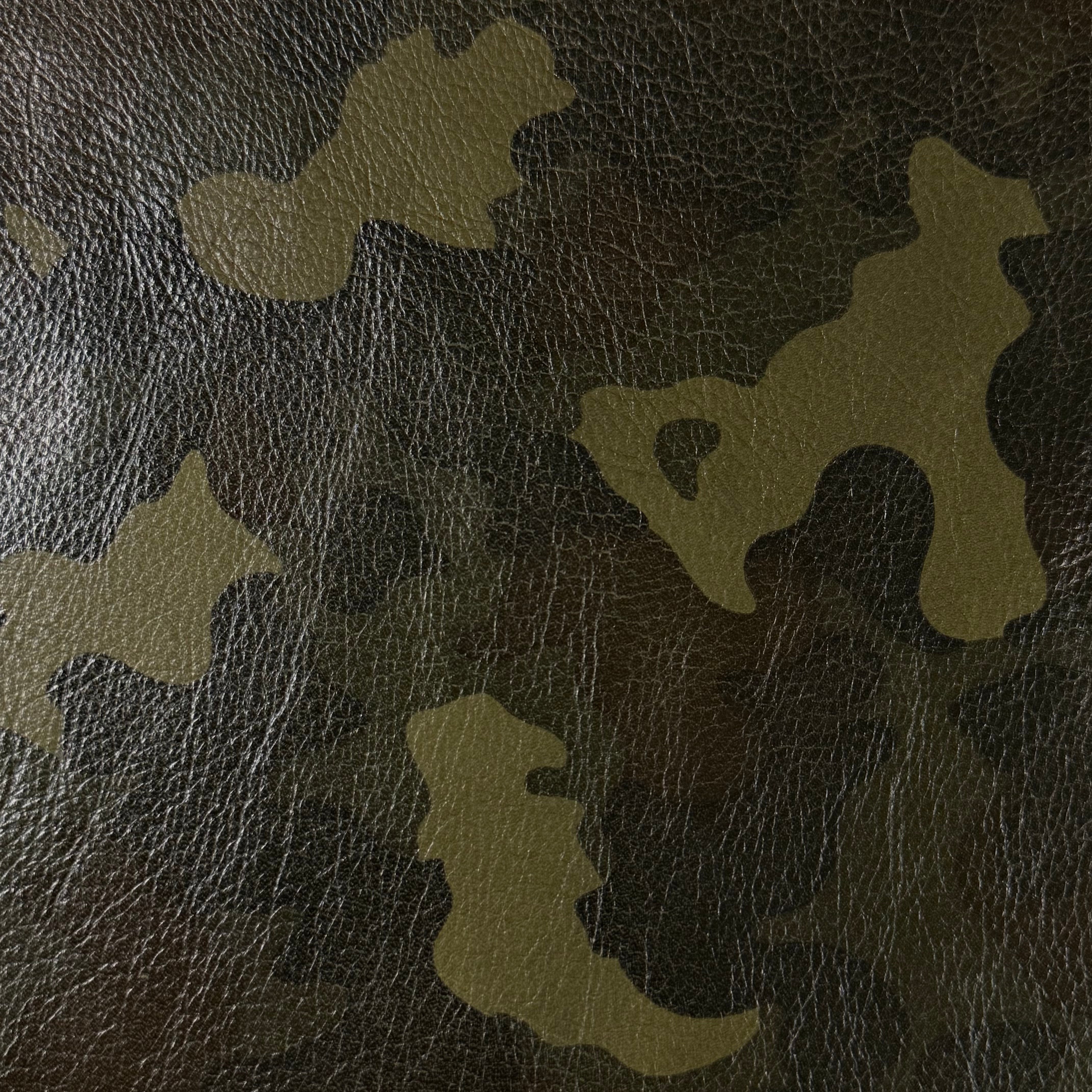 Camouflage Milled Floater Cow 3 oz leather in Woodland Camo with a textured, pebbled grain finish.