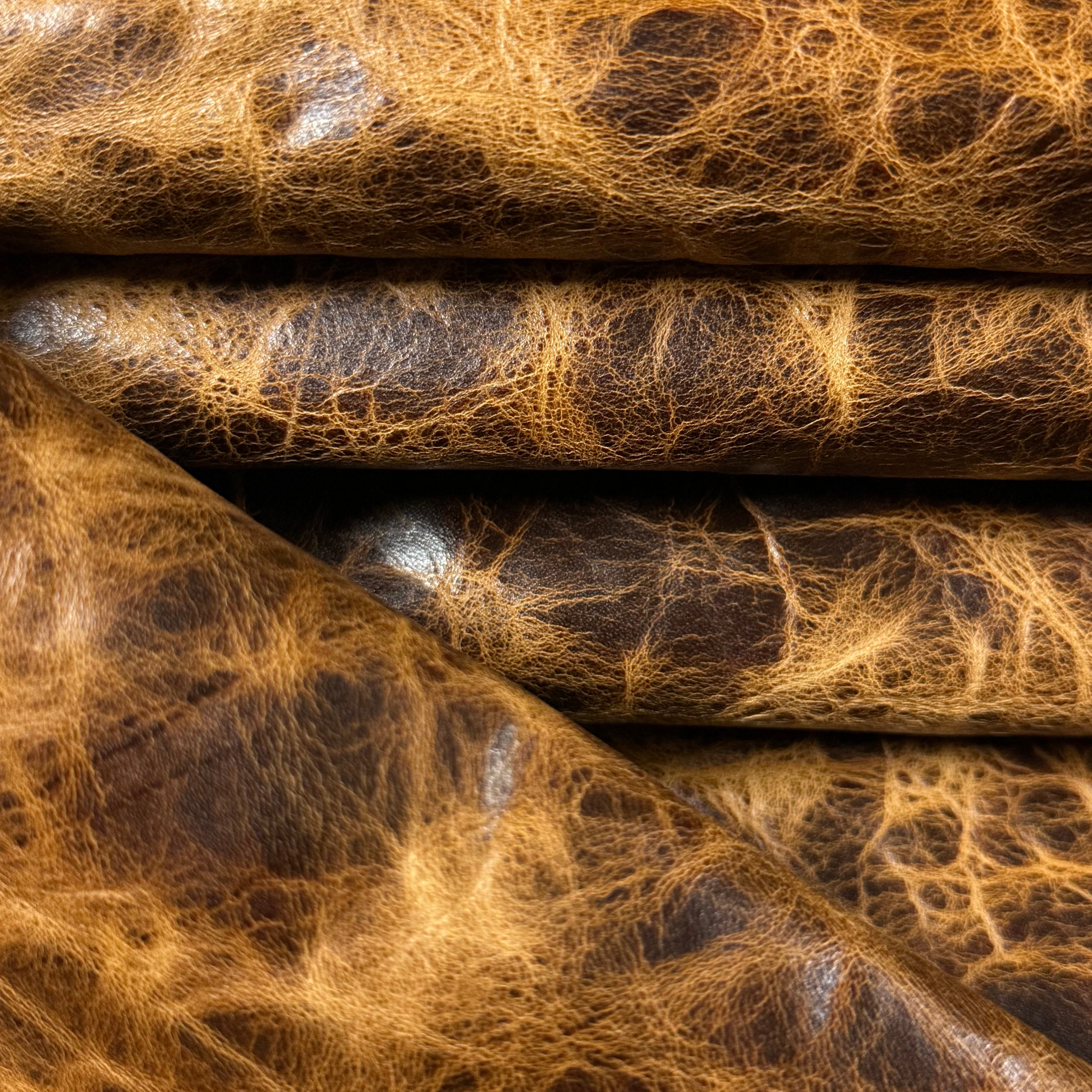 Tan Carnauba Waxed Pull-Up Cowhide leather, 2-3 oz, featuring a distressed, textured grain and rich, multi-tonal finish.
