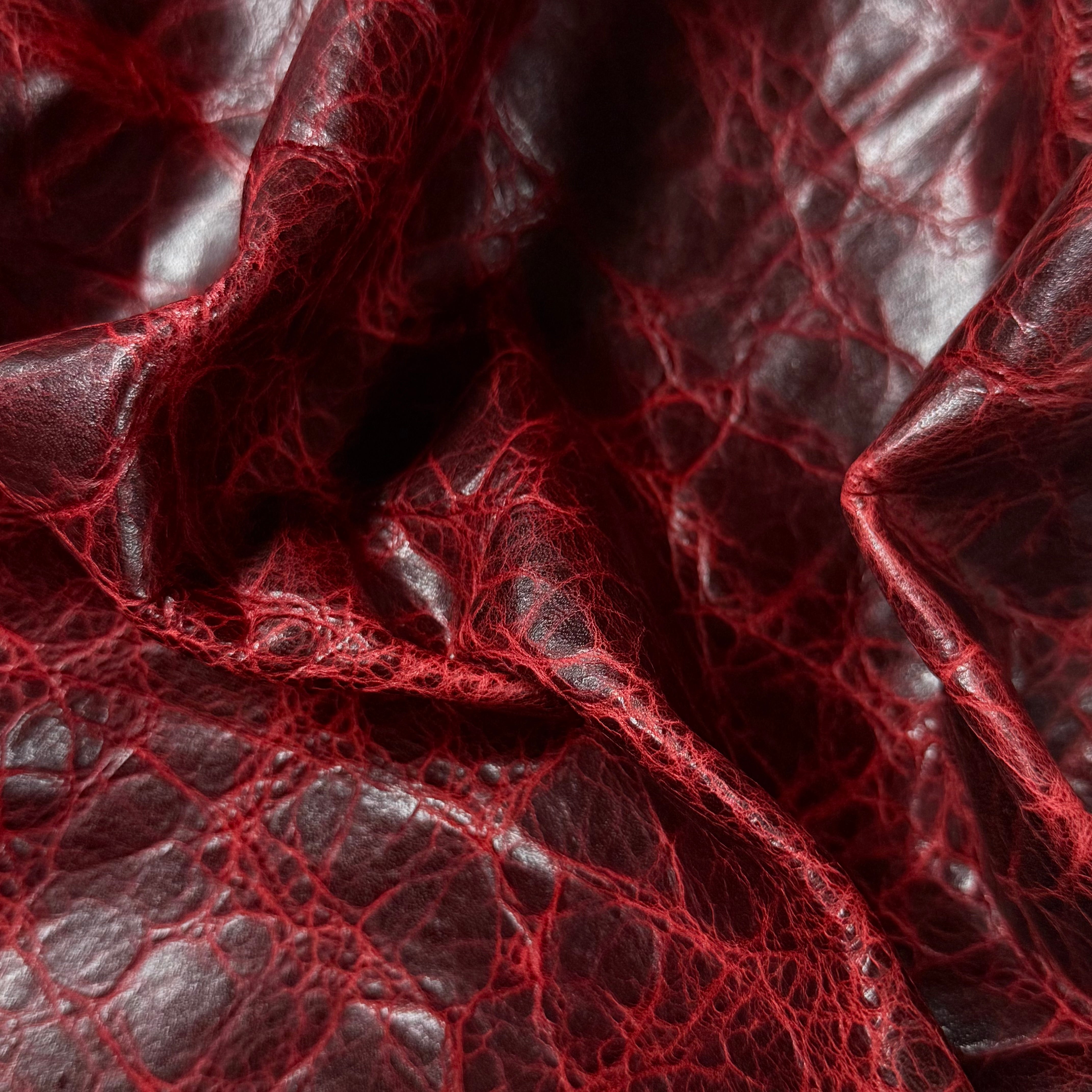 Deep red Carnauba waxed pull-up cowhide leather, 2-3 oz, featuring a rich, crinkled texture and glossy finish.