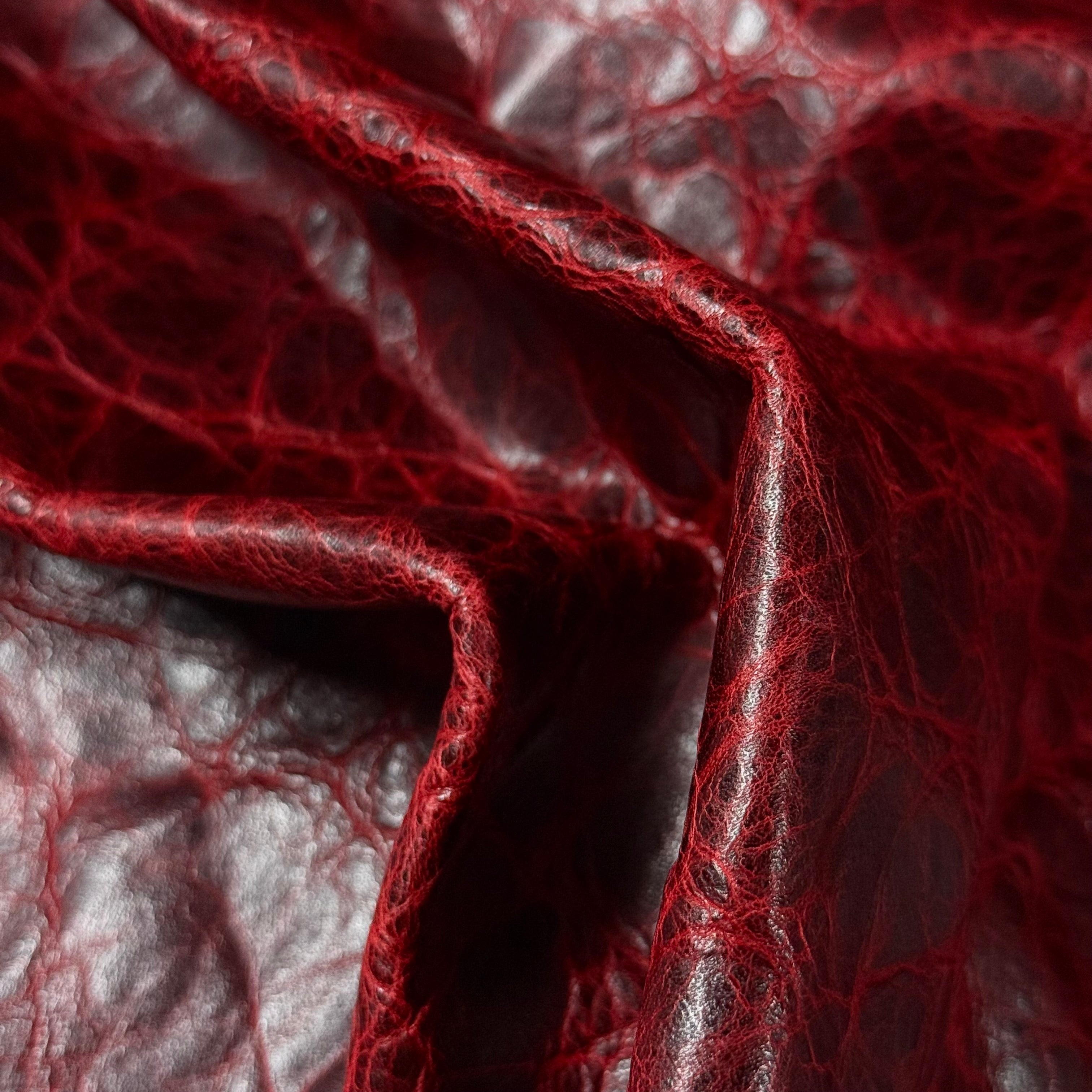 Deep red Carnauba waxed pull-up cowhide leather, 2-3 oz, featuring a rich, textured, and distressed finish.