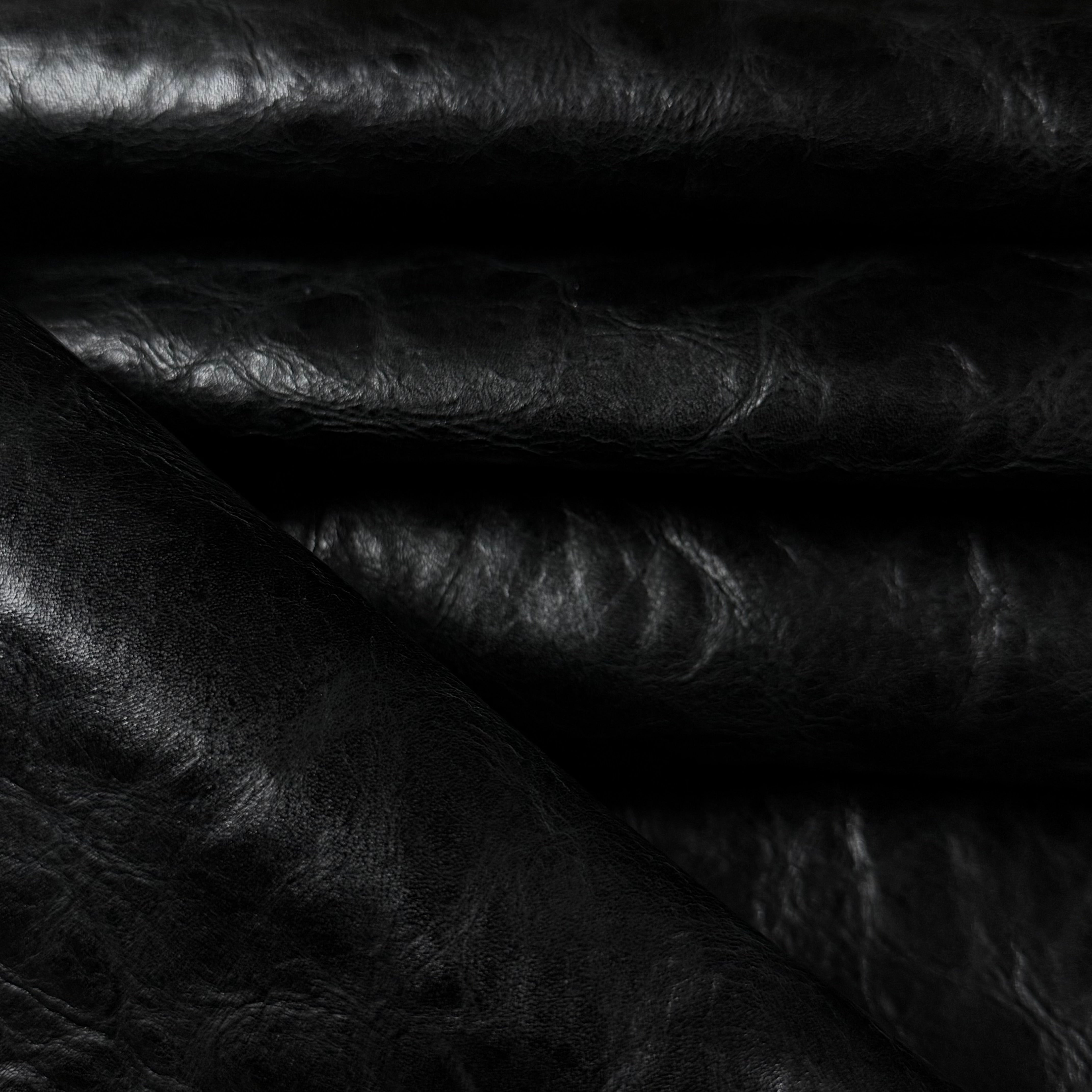 Black Carnauba Waxed Pull-Up Cowhide leather, 2-3 oz, featuring a rich, textured, and glossy dark finish.