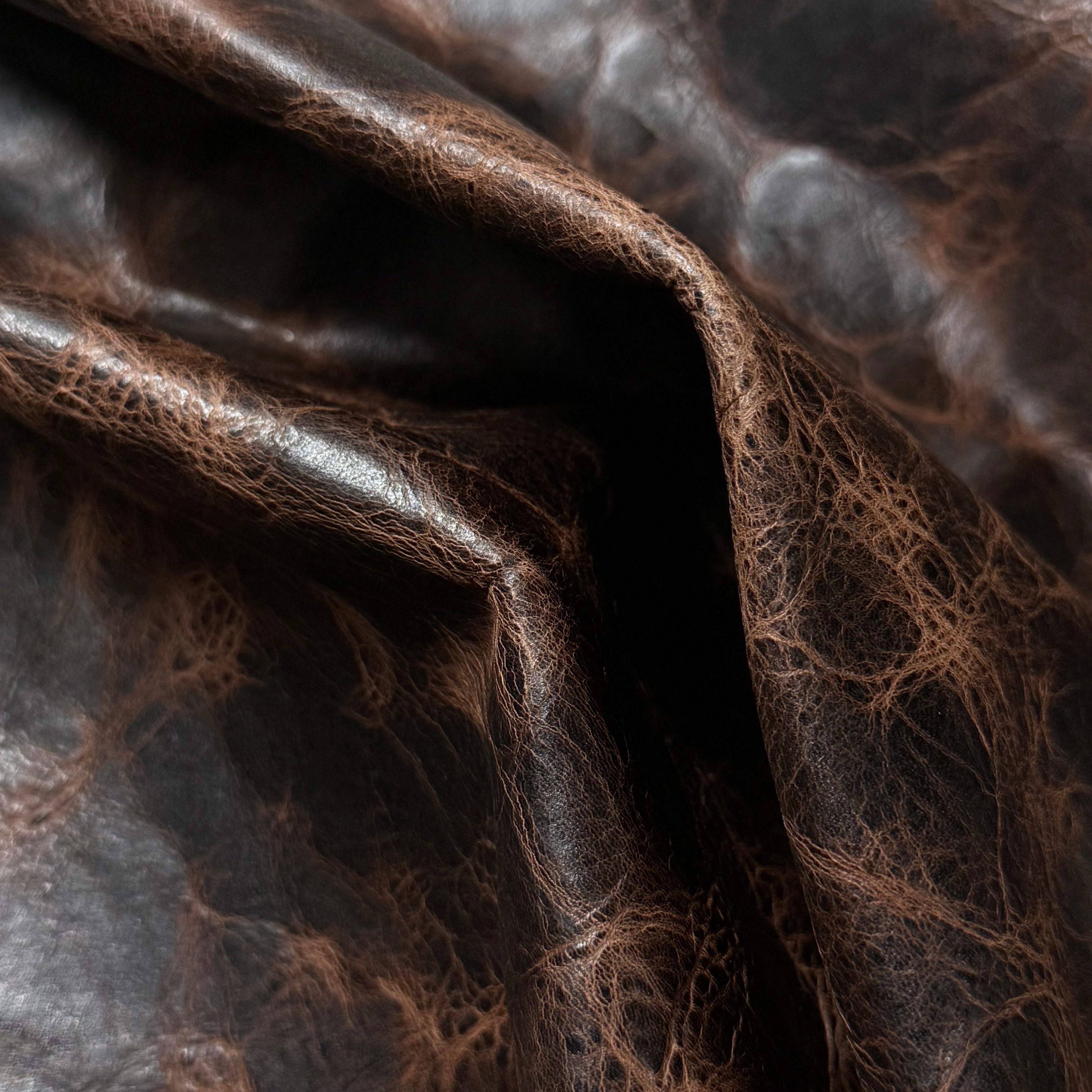 Dark brown Carnauba Waxed Pull-Up Cowhide, 2-3 oz leather with a distressed, textured finish and natural grain.