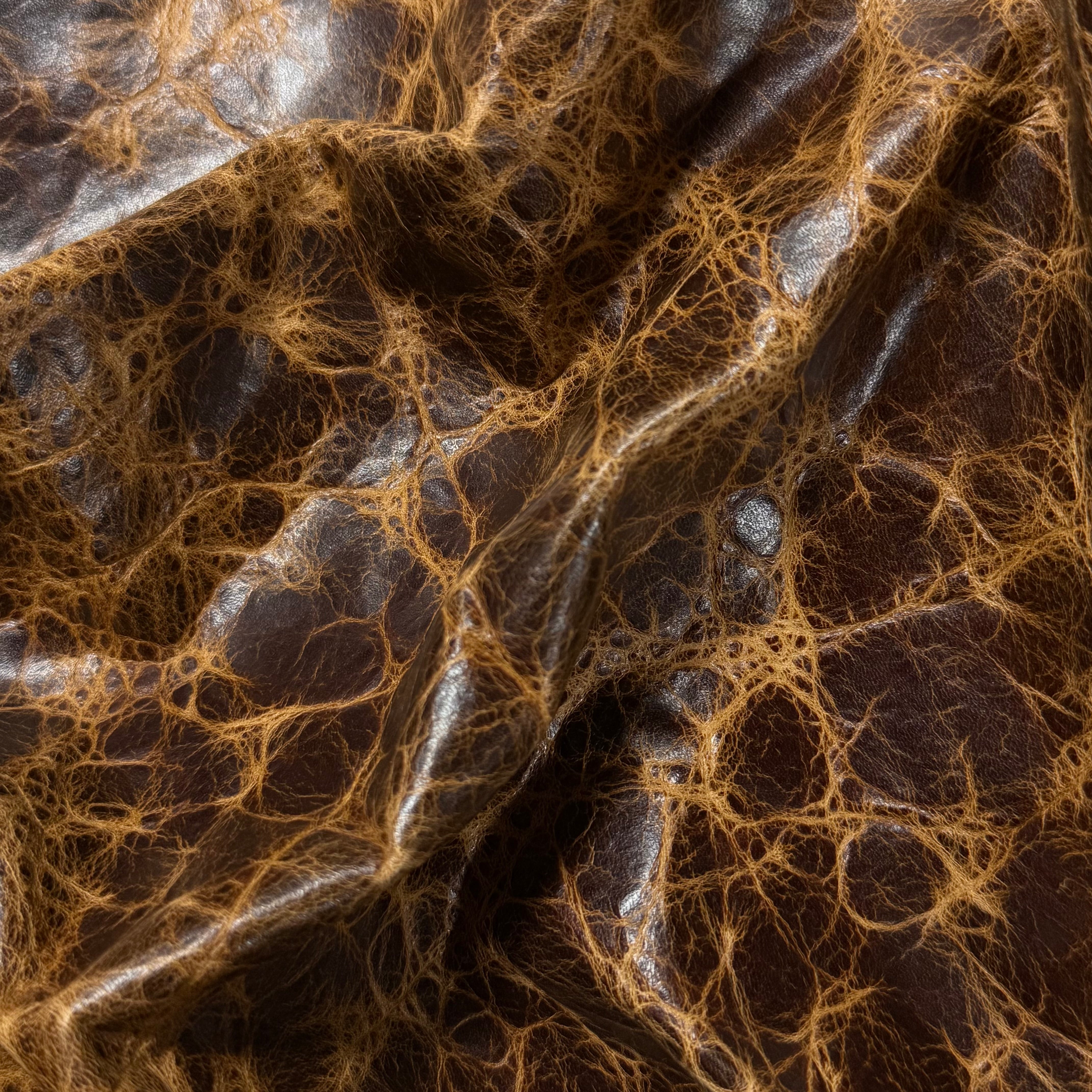 Brown Carnauba Waxed Pull-Up Cowhide leather, 2-3 oz, featuring a distressed, textured finish with deep brown and tan tones.
