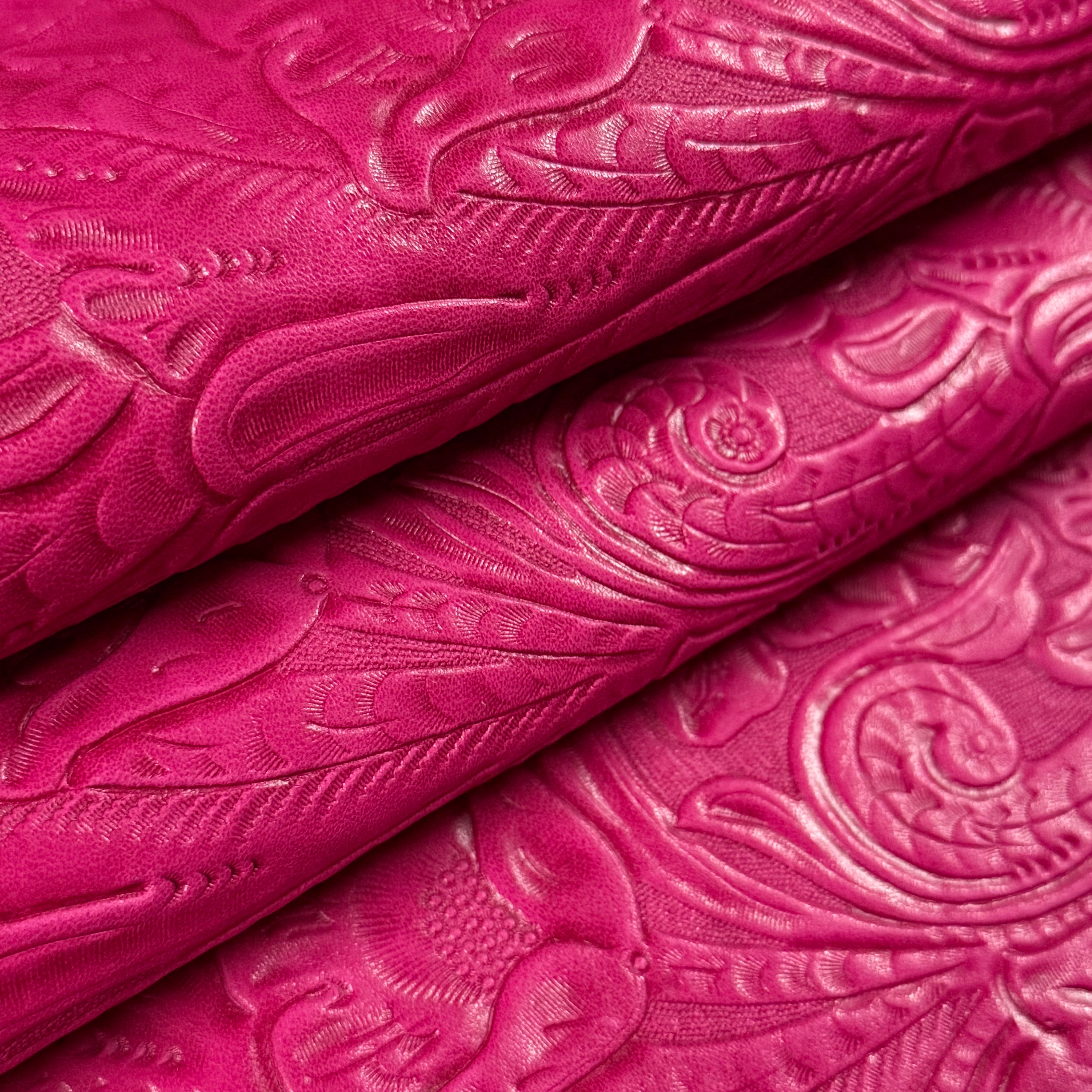 Vibrant fuchsia floral embossed oiled veg tan lamb leather, showing intricate Sheridan pattern.
