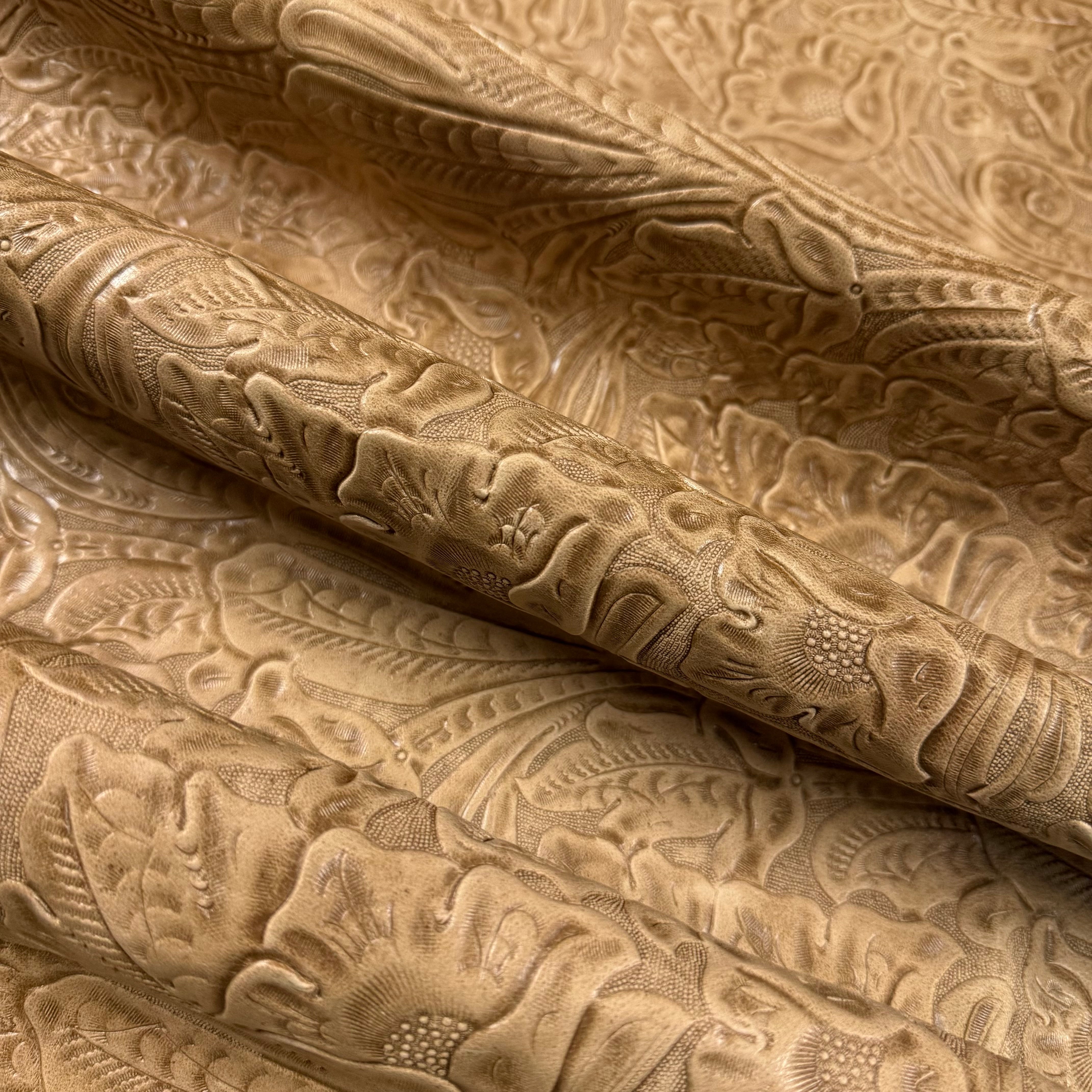 Light brown floral embossed oiled veg tan lamb leather, showing intricate Sheridan pattern and supple texture.