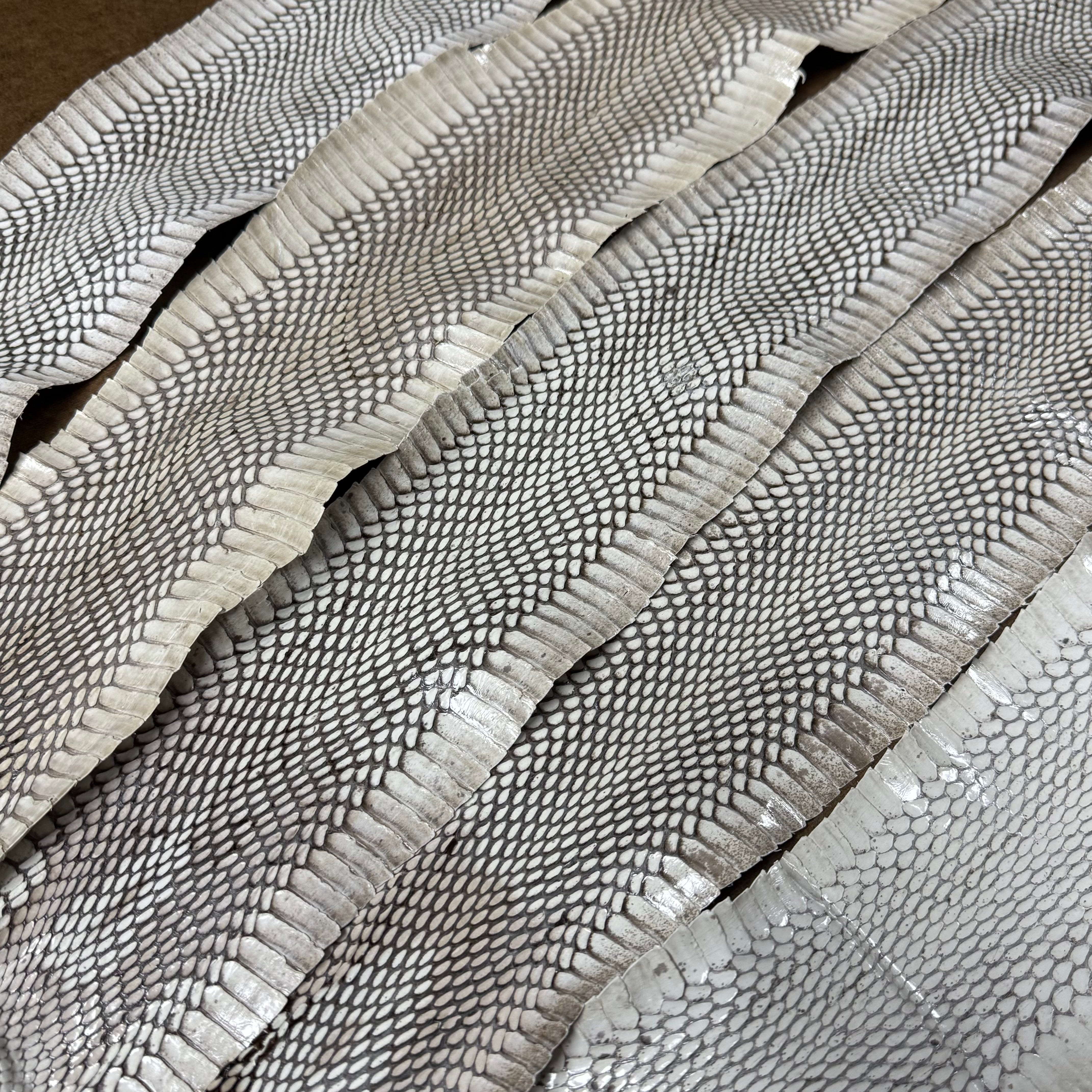 Cobra leather strips in off-white featuring a natural, textured snakeskin scale pattern and matte finish.