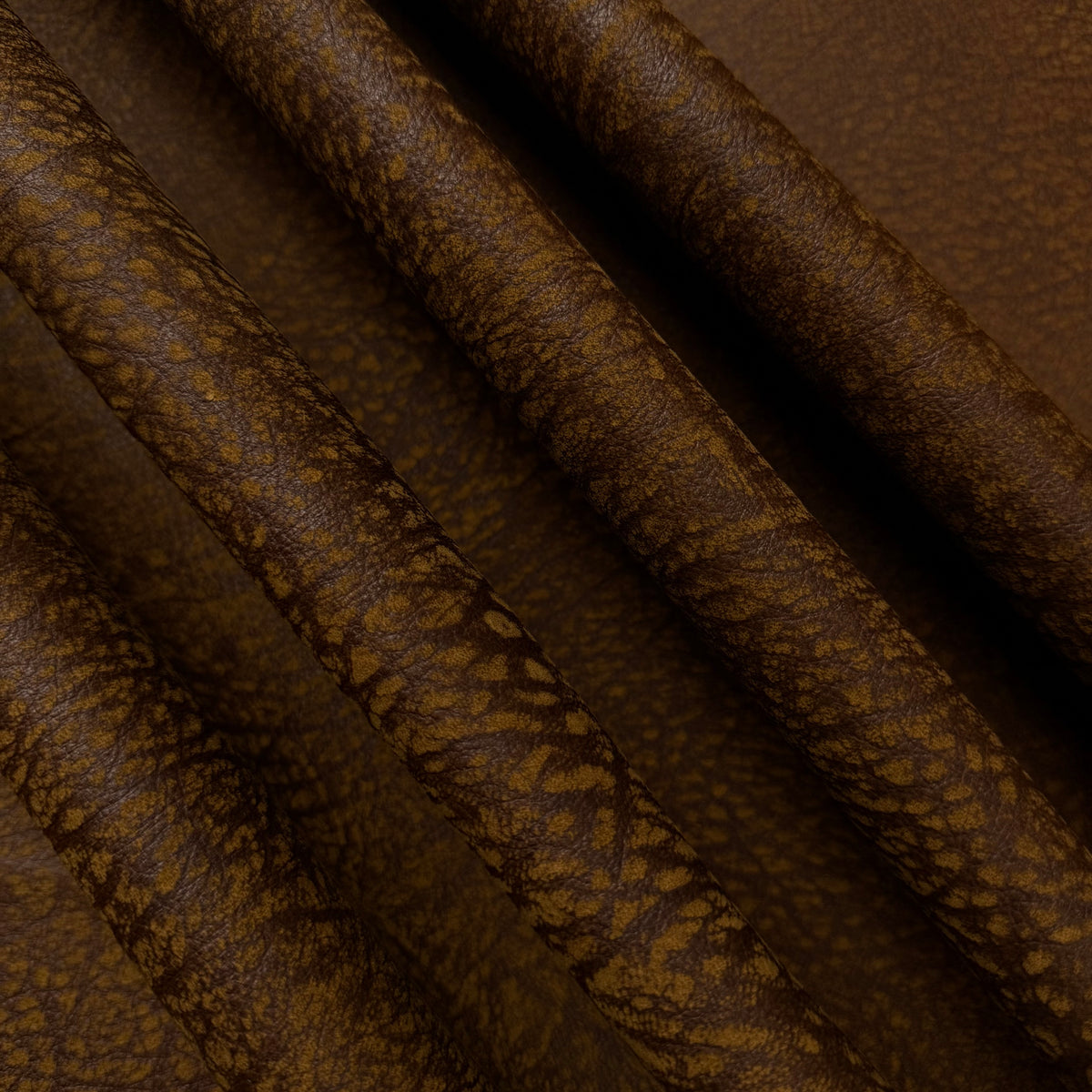 Brown distressed buffed elephant embossed cowhide leather, 3 oz, featuring a textured, rugged grain pattern.
