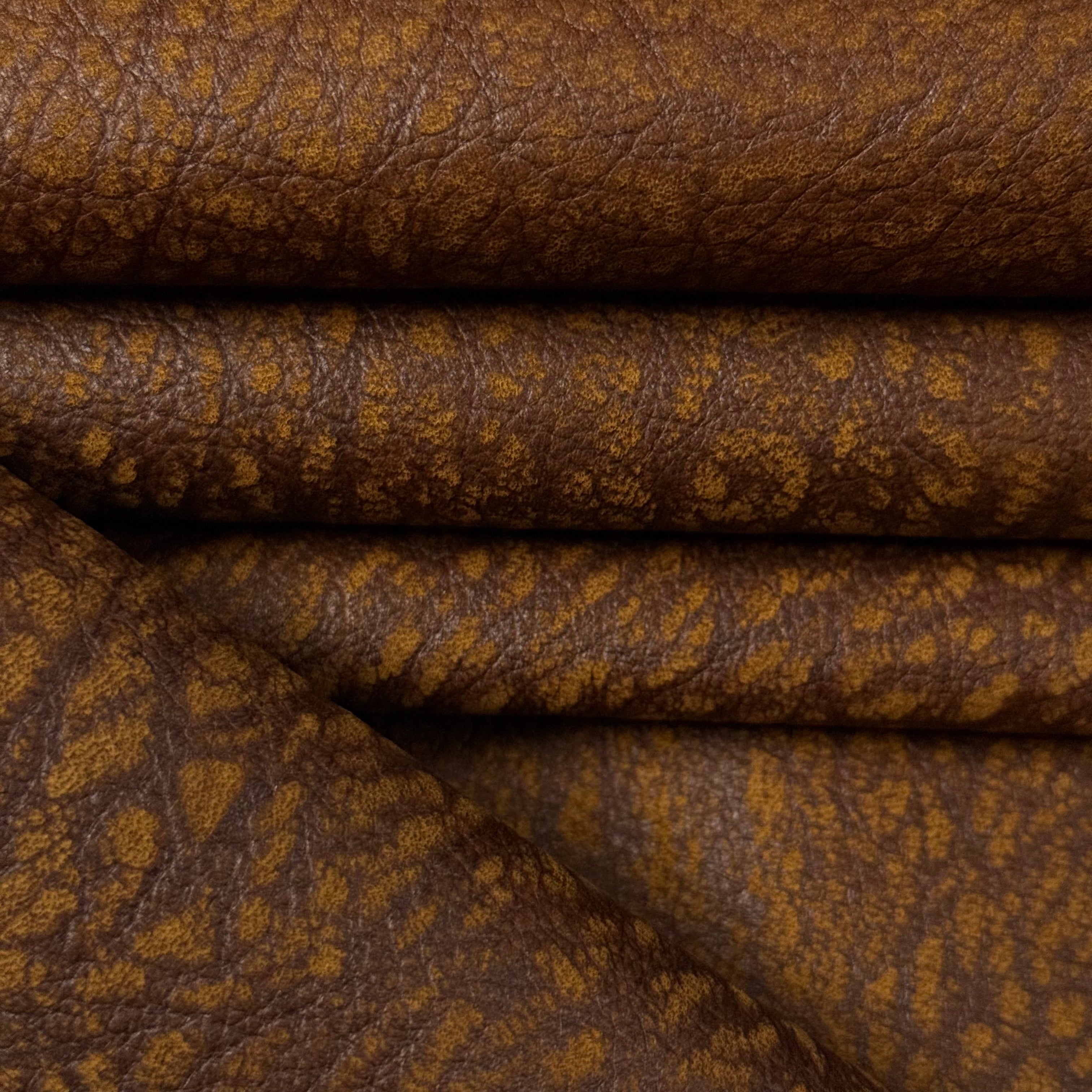 Brown Distressed Buffed Elephant Embossed Cowhide leather, 3 oz, featuring a textured, multi-tonal grain pattern.