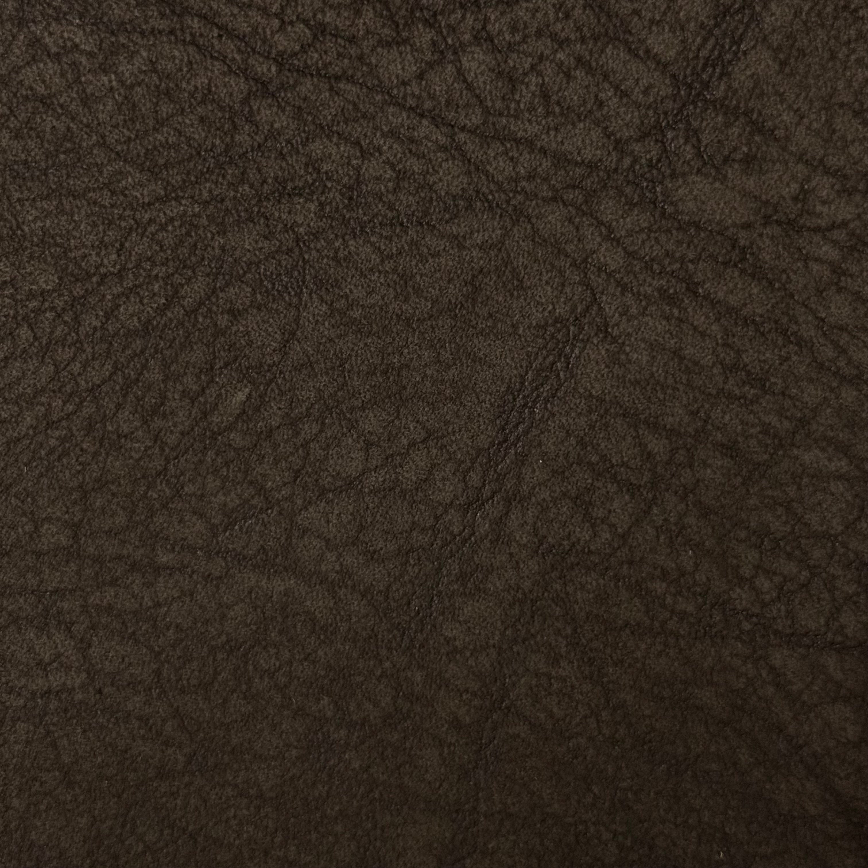 Dark brown distressed buffed elephant embossed cowhide leather, 3 oz weight with a textured, rugged finish.