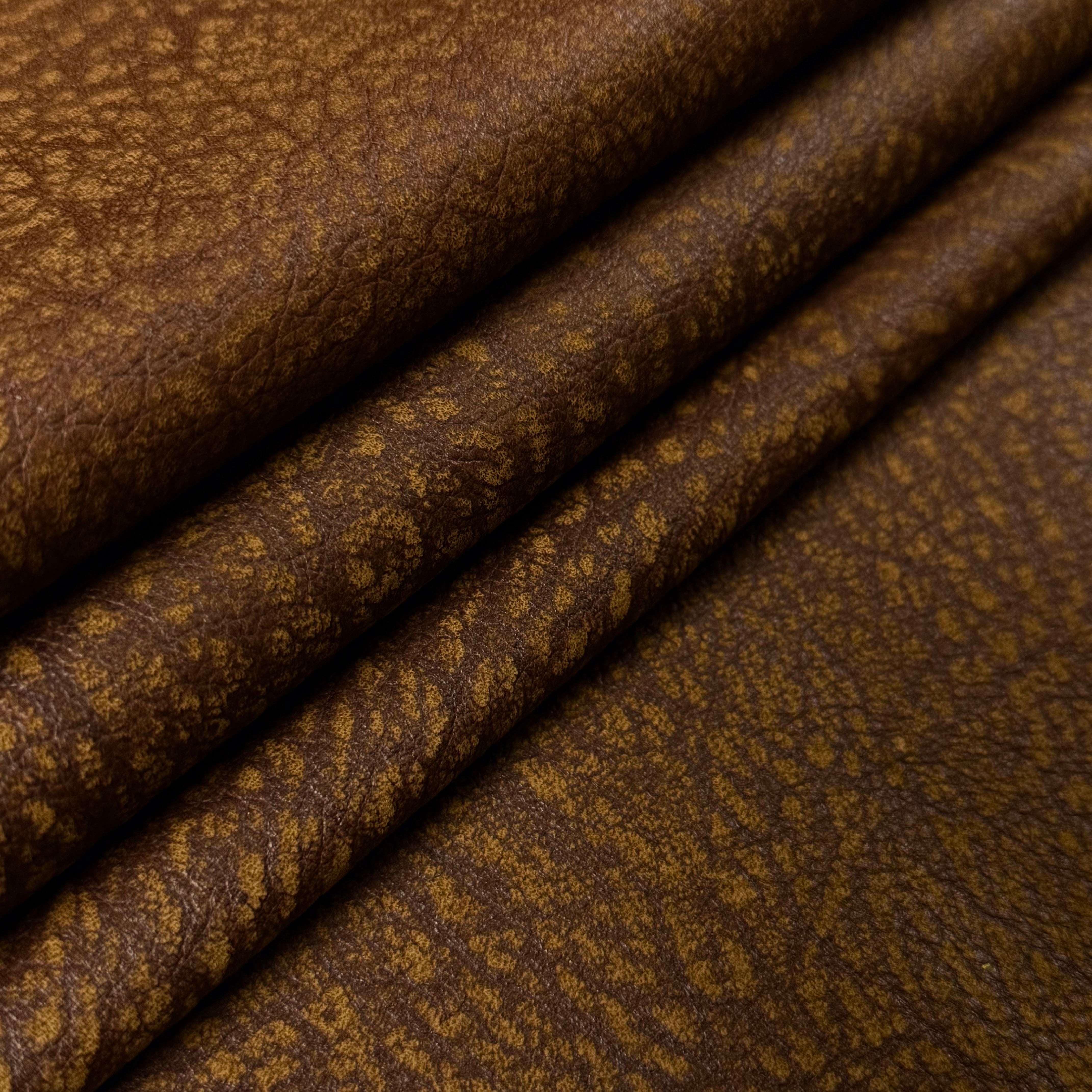 Brown distressed buffed elephant embossed cowhide leather, 3 oz, featuring a textured, rugged grain pattern.