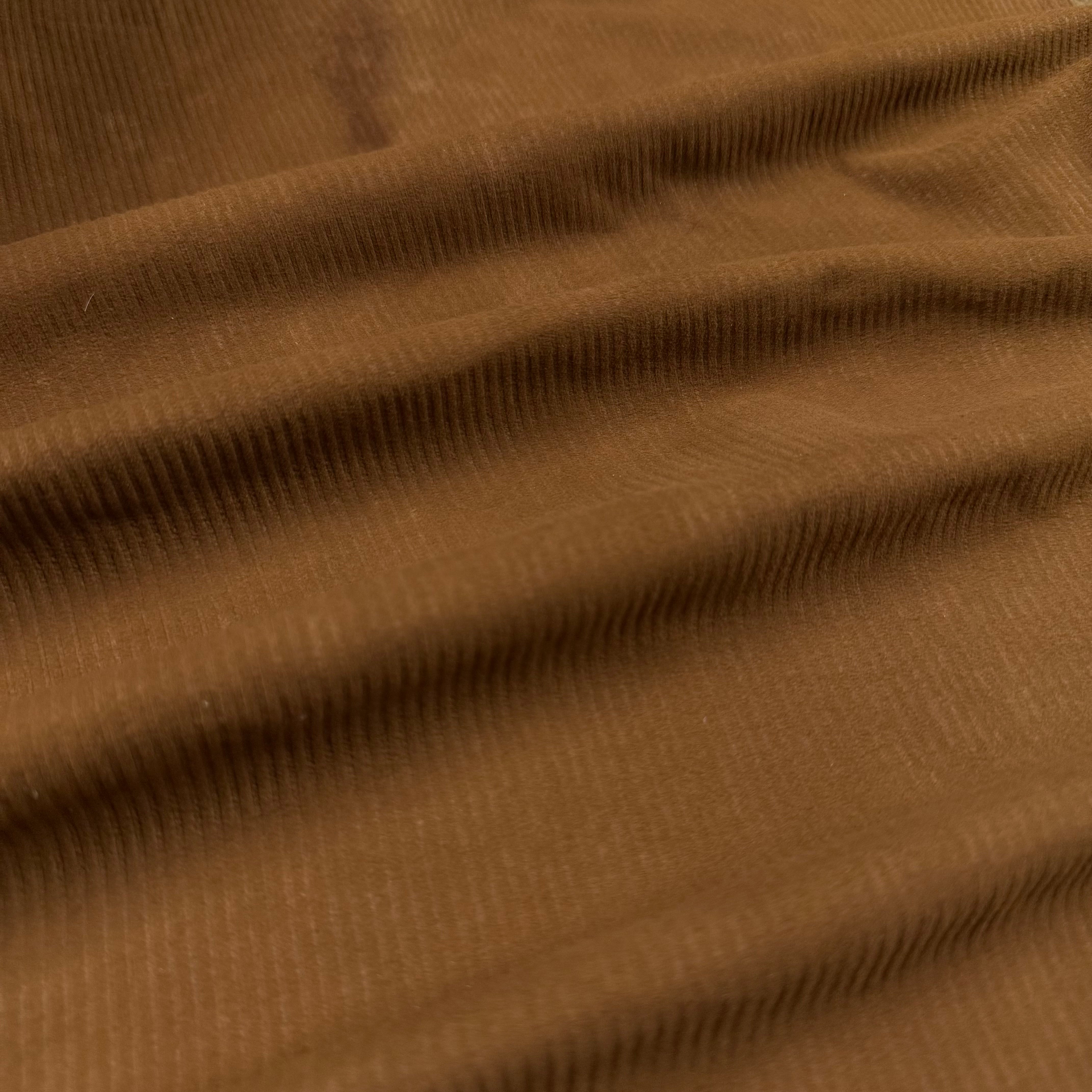 Close-up of rich brown Corduroy Metis Lamb Suede with visible ribbed texture and soft folds.