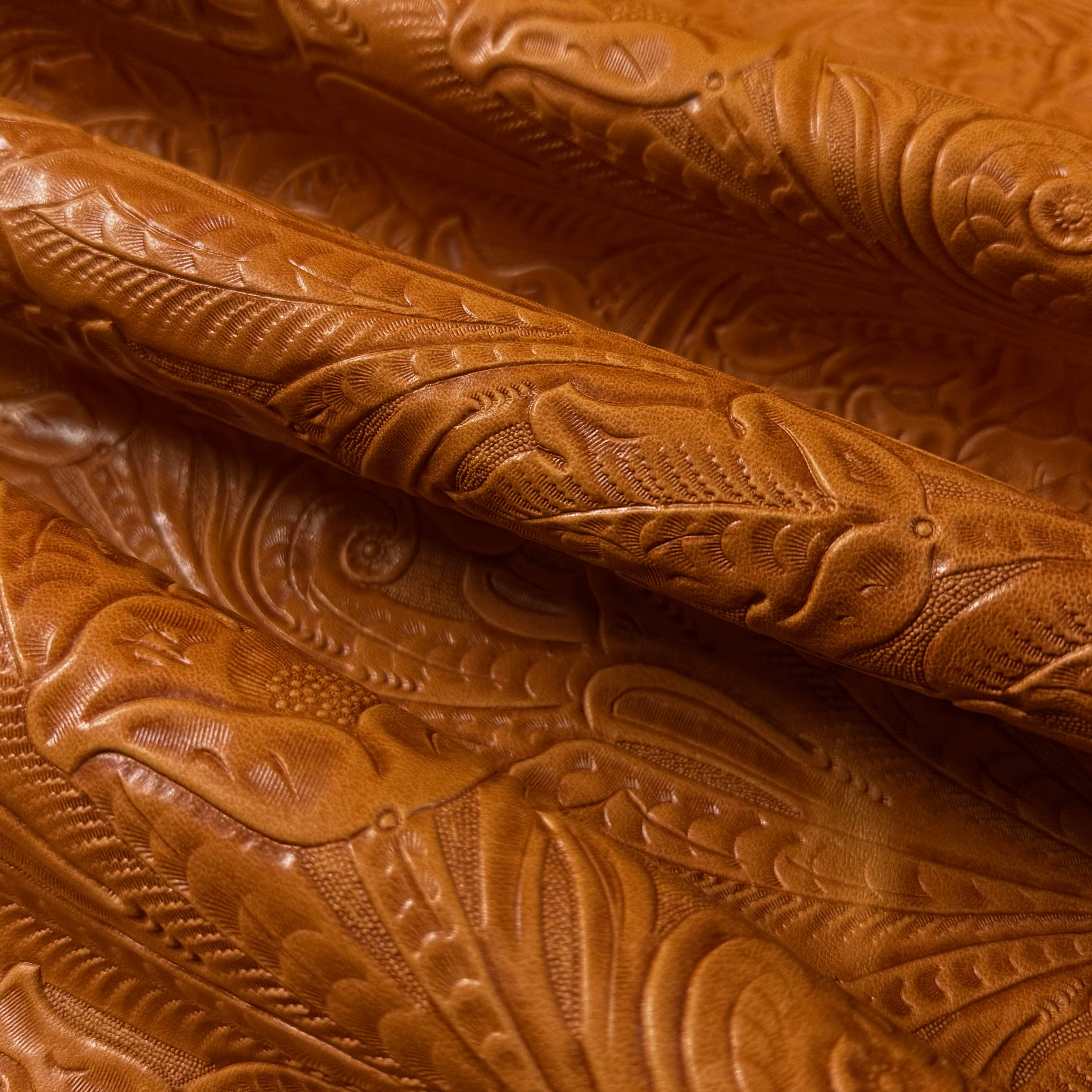 Brown floral embossed oiled veg tan lamb leather with a Sheridan pattern.