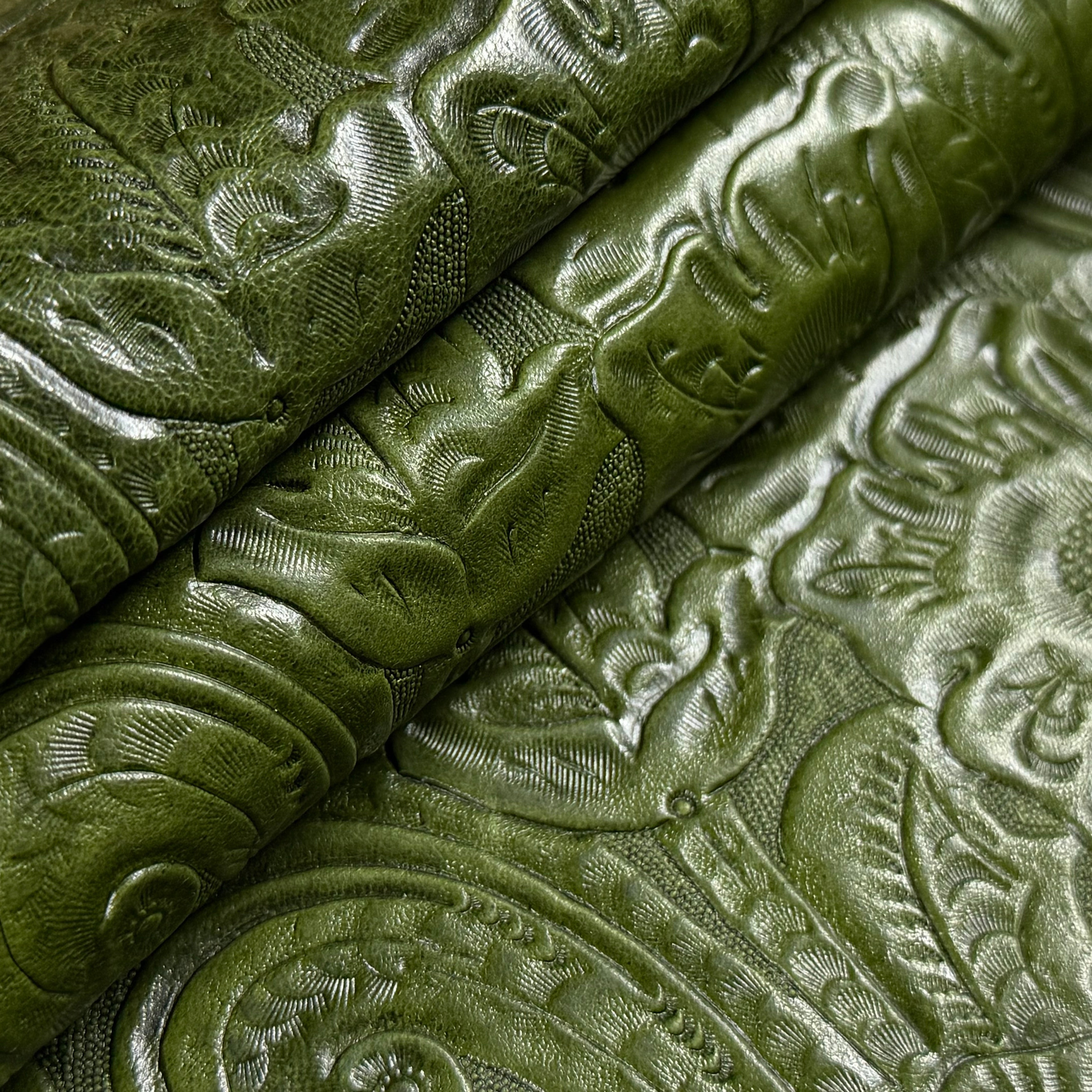 Green floral embossed oiled veg tan lamb leather, folded to show texture.