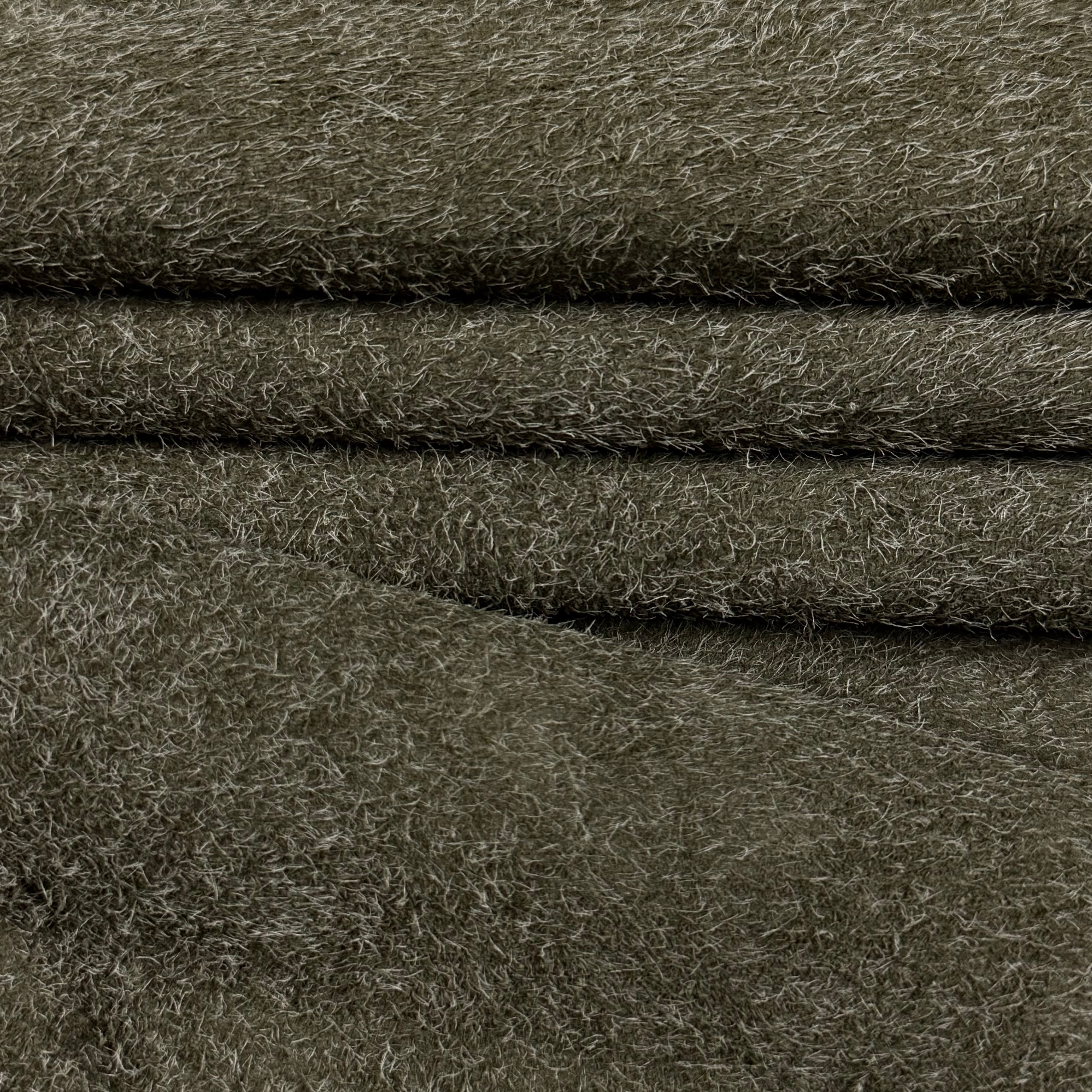 Folded olive green hairy calf suede leather with long, shaggy fibers and a rough-out texture.