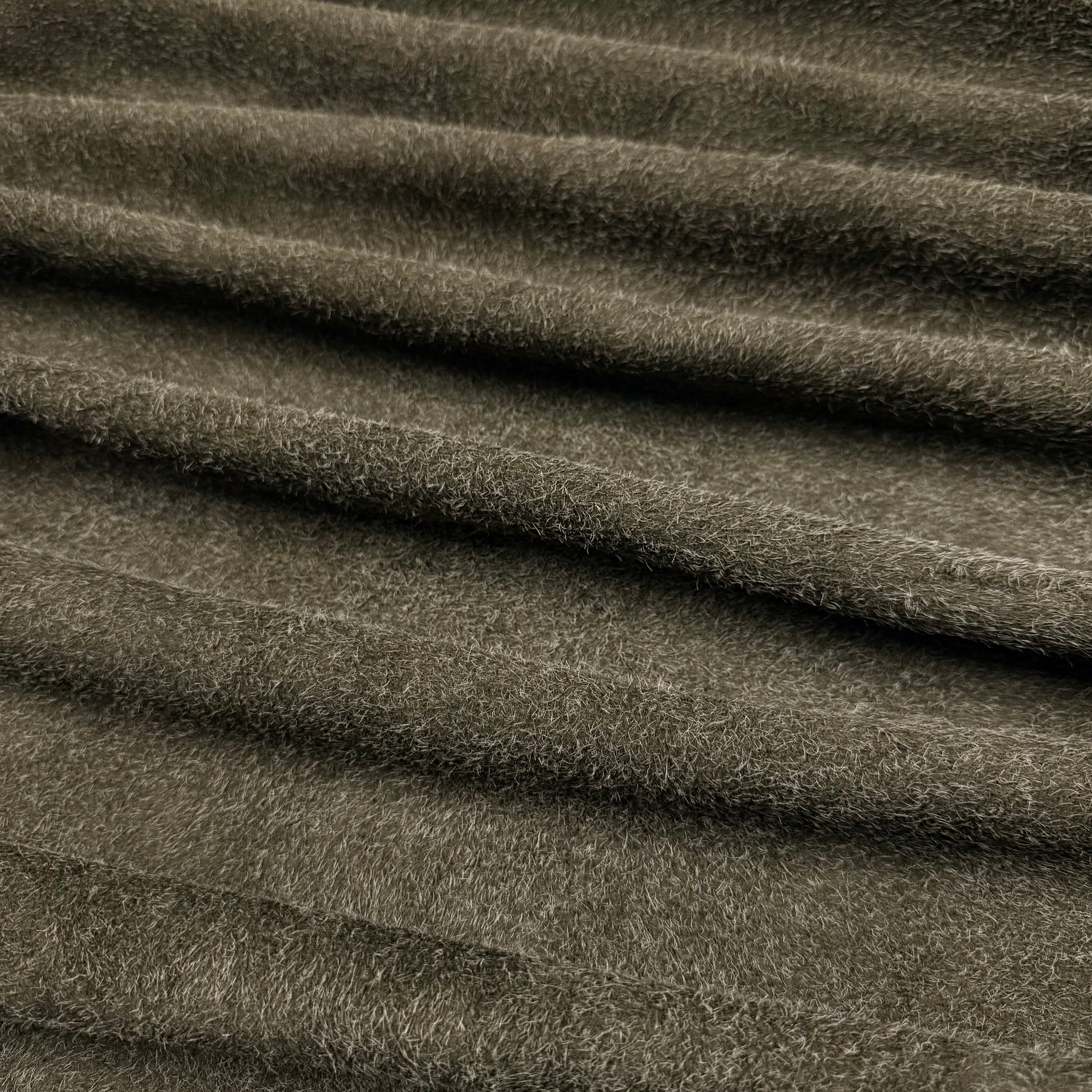 Folded olive green hairy calf suede leather with a rough-out texture and long, shaggy fibers.