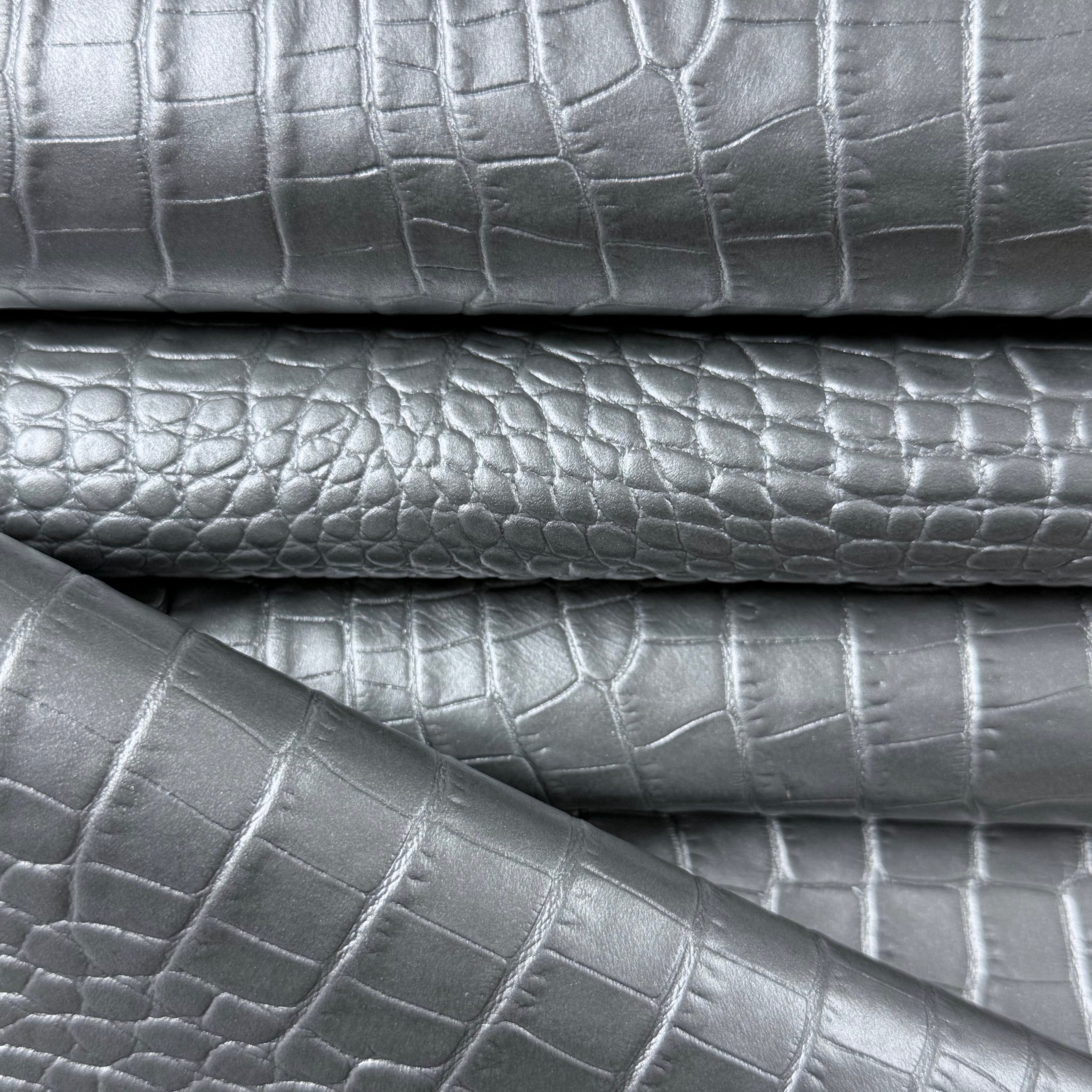 Silver pearlized crocodile embossed cow leather, 2-3 oz weight with a textured, metallic reptilian finish.